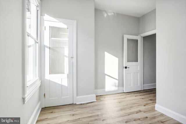 unfurnished room with light wood-type flooring