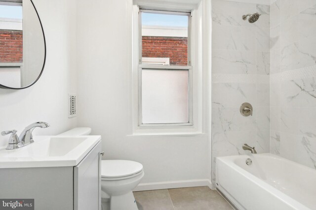 full bathroom with toilet, vanity, tiled shower / bath, and tile patterned flooring