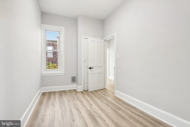 spare room with light wood-type flooring