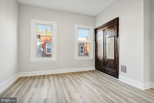 foyer featuring a wealth of natural light and light hardwood / wood-style floors