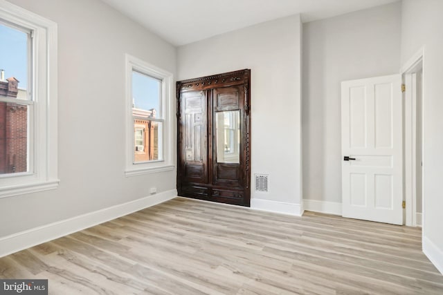 entrance foyer featuring plenty of natural light and light hardwood / wood-style flooring