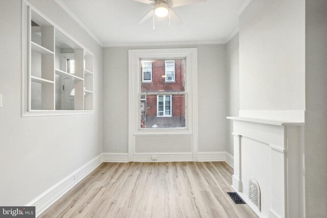 spare room with ceiling fan, light wood-type flooring, and ornamental molding