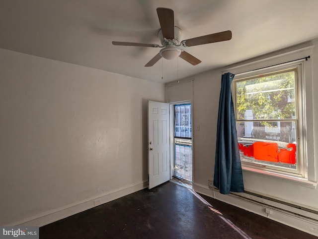 1909 E Wishart St, Philadelphia, PA 19134 - empty room featuring a baseboard radiator, baseboards, dark wood-style floors, and ceiling fan