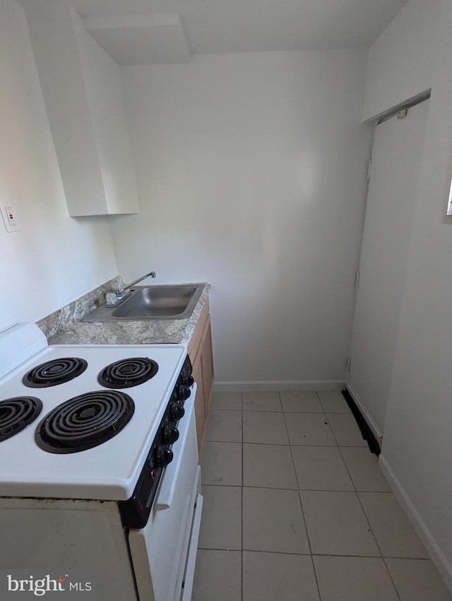 1909 E Wishart St, Philadelphia, PA 19134 - kitchen featuring a sink, light tile patterned floors, light countertops, electric range, and baseboards