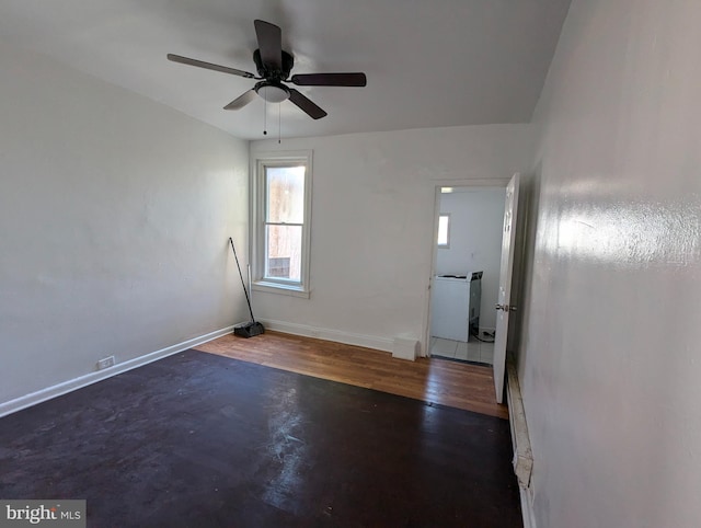 empty room with dark hardwood / wood-style floors and ceiling fan