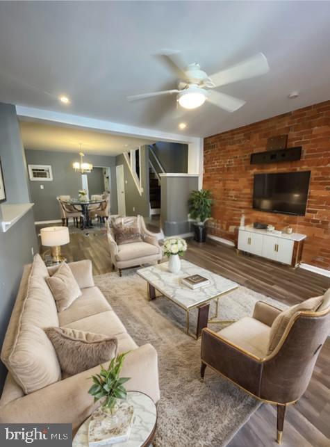 living room featuring dark hardwood / wood-style floors and ceiling fan