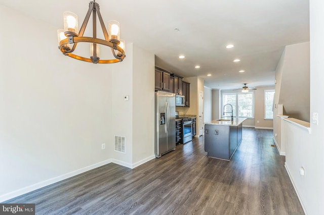 kitchen featuring dark brown cabinets, a center island with sink, dark hardwood / wood-style flooring, sink, and stainless steel appliances