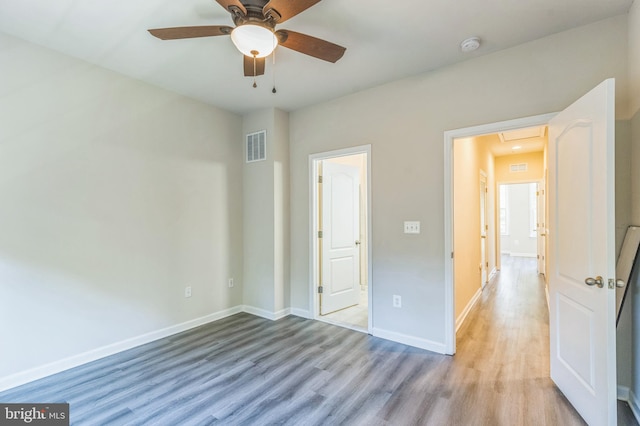 unfurnished bedroom with light wood-type flooring and ceiling fan