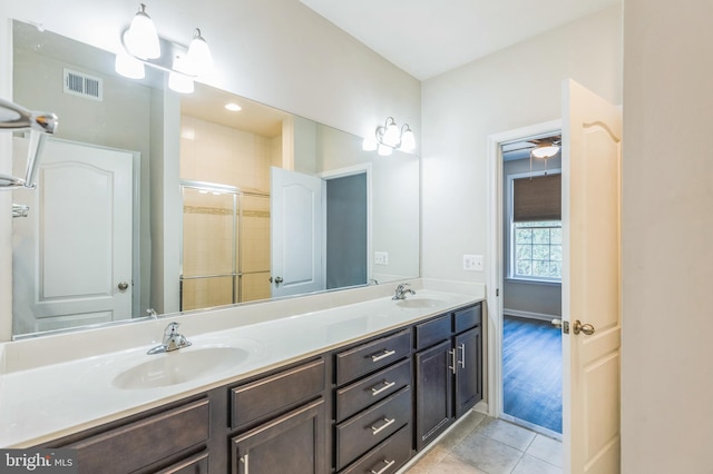 bathroom featuring walk in shower, vanity, ceiling fan, and tile patterned floors