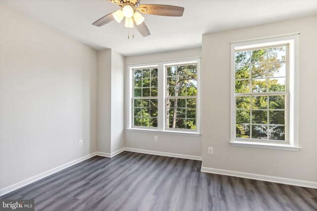 empty room with dark wood-type flooring and ceiling fan