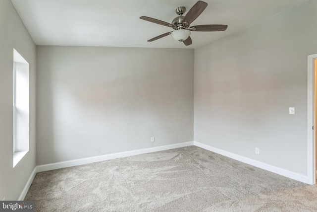 unfurnished room with ceiling fan and light colored carpet