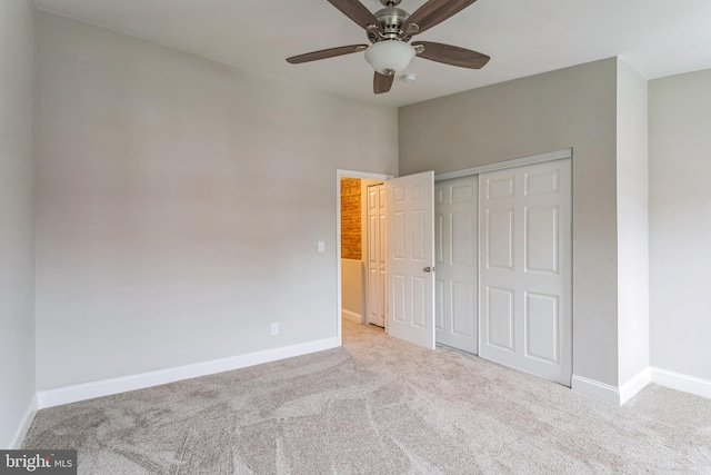 unfurnished bedroom featuring a closet, ceiling fan, and light colored carpet