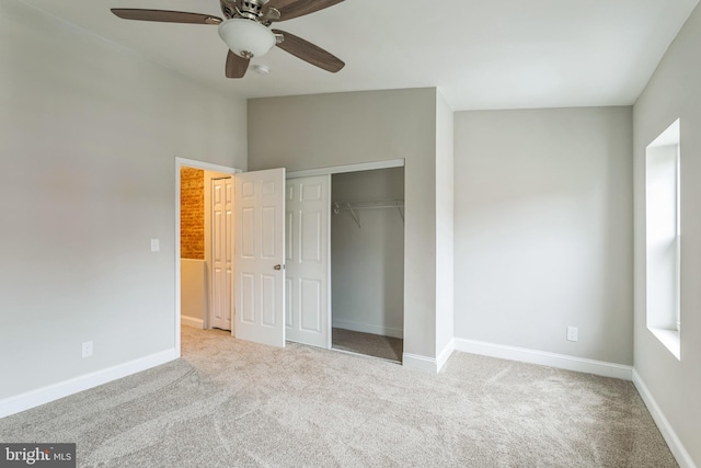 unfurnished bedroom featuring light carpet, a closet, and ceiling fan