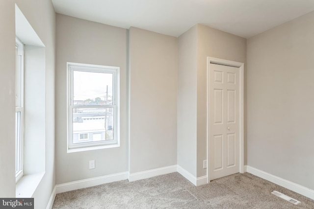 spare room with light colored carpet