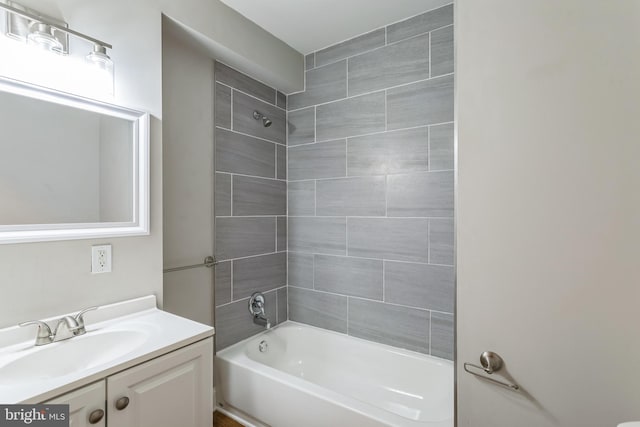 bathroom featuring vanity and tiled shower / bath