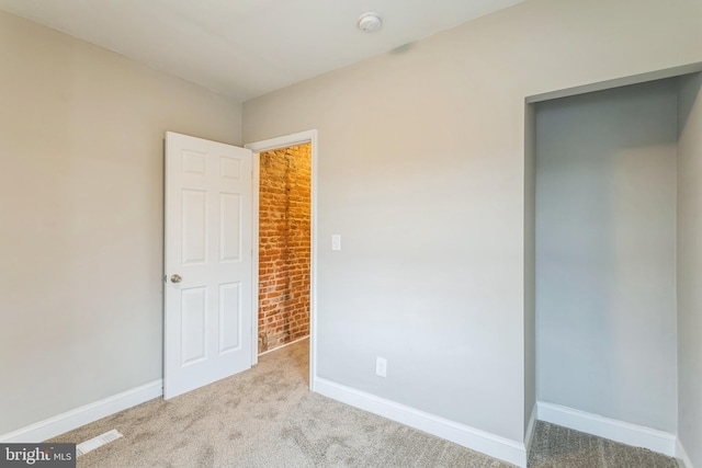 unfurnished bedroom with light colored carpet