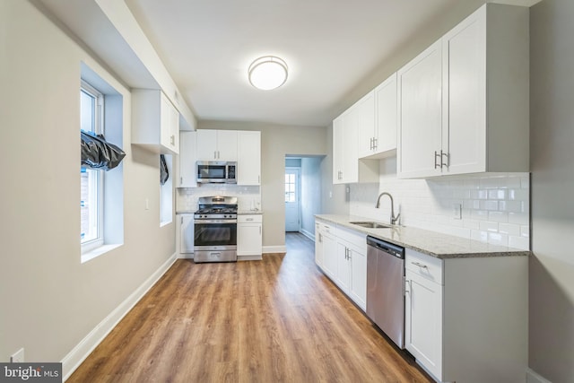 kitchen featuring appliances with stainless steel finishes, sink, and white cabinets