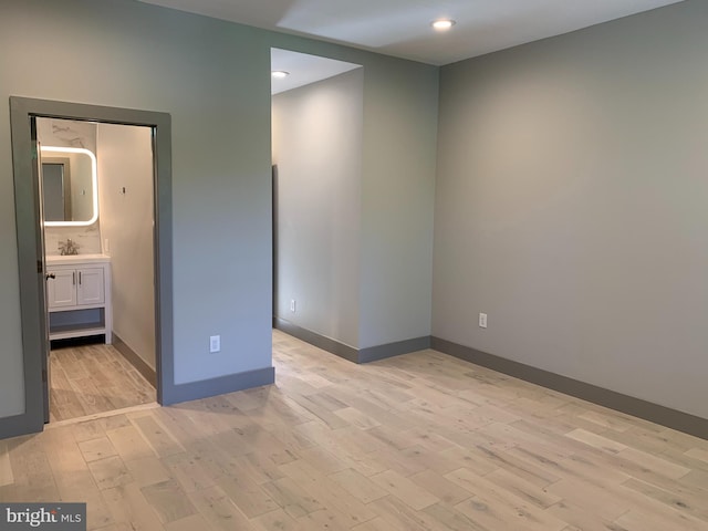 empty room with light hardwood / wood-style flooring