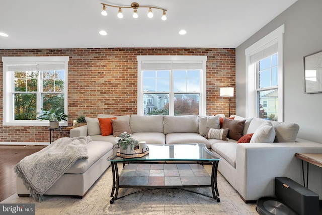 living room featuring light hardwood / wood-style flooring and brick wall