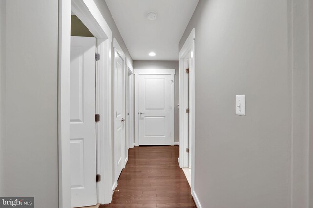 corridor featuring dark hardwood / wood-style floors