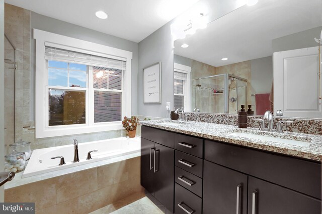 bathroom featuring vanity and shower with separate bathtub