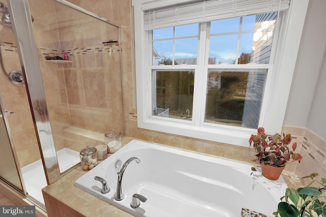 bathroom featuring separate shower and tub