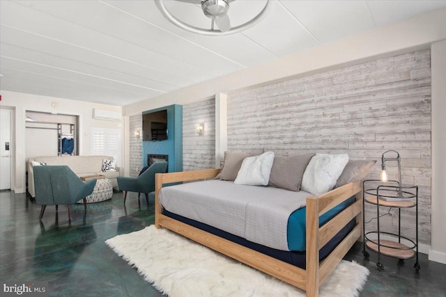 bedroom featuring an AC wall unit and a fireplace