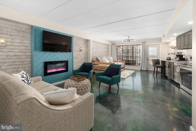 living room featuring wooden walls and a large fireplace