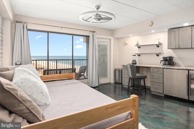 bedroom featuring access to exterior, a water view, and stainless steel refrigerator