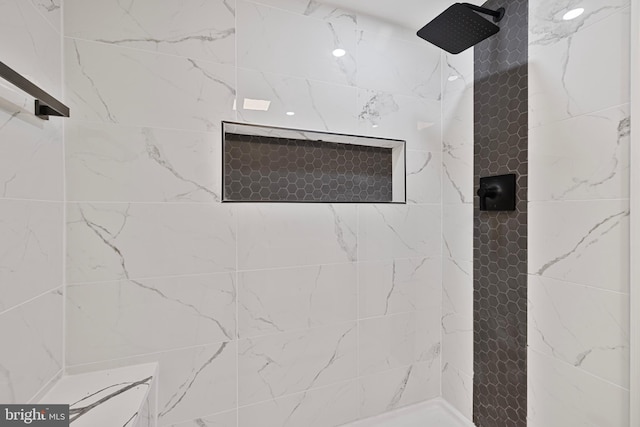 bathroom with a tile shower