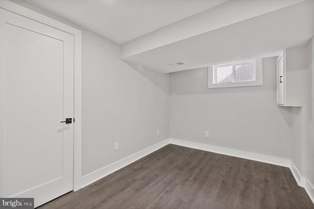 basement with dark wood-style floors and baseboards