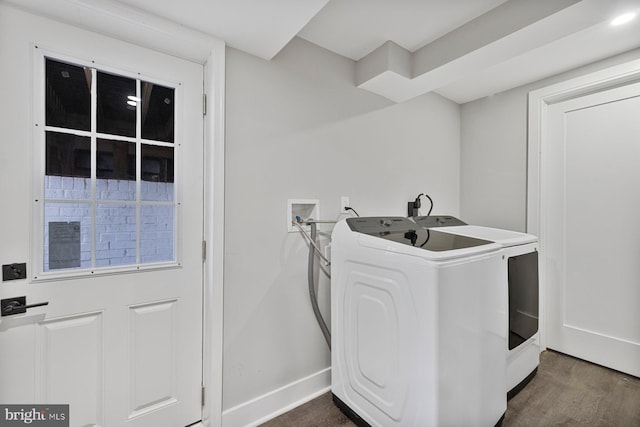 laundry area featuring dark wood-style flooring, baseboards, and separate washer and dryer