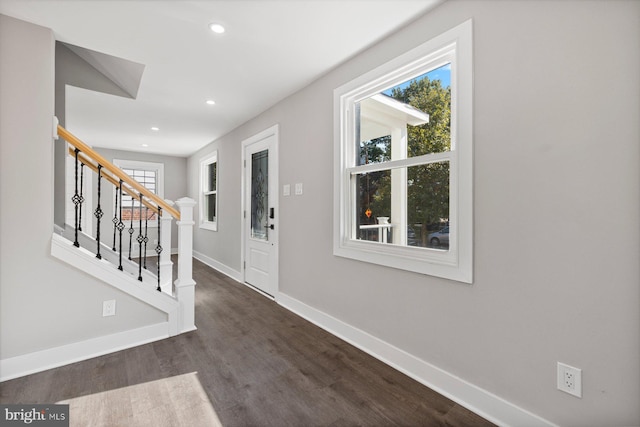 entryway with baseboards, recessed lighting, dark wood-type flooring, and stairway