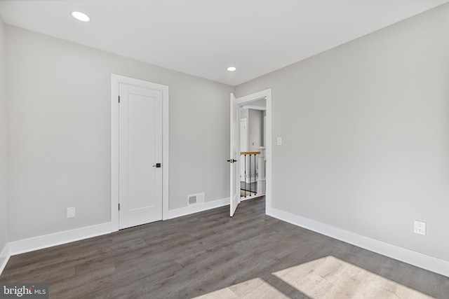 empty room with dark hardwood / wood-style floors