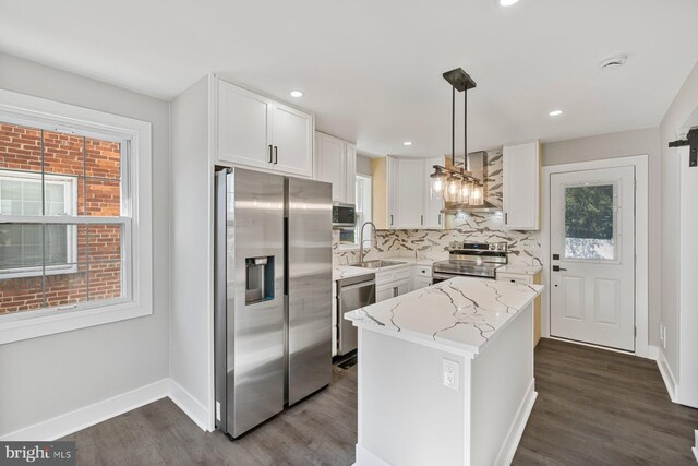 kitchen with stainless steel appliances, a sink, dark wood-style flooring, white cabinets, and recessed lighting