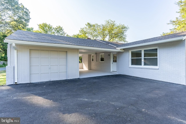 ranch-style home featuring a carport and a garage