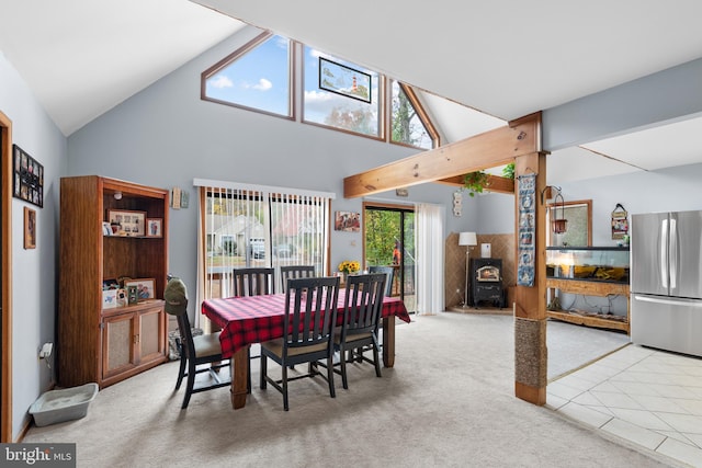 carpeted dining room with high vaulted ceiling