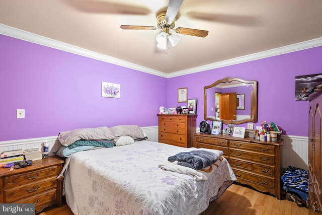 bedroom with ceiling fan, light hardwood / wood-style floors, and crown molding