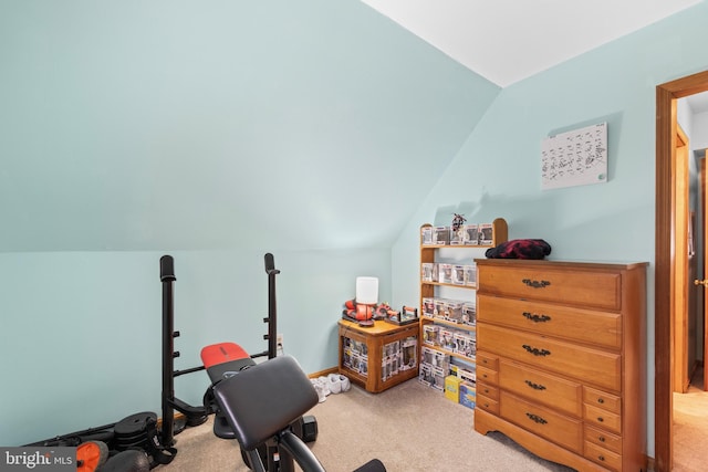 workout room with light carpet and vaulted ceiling