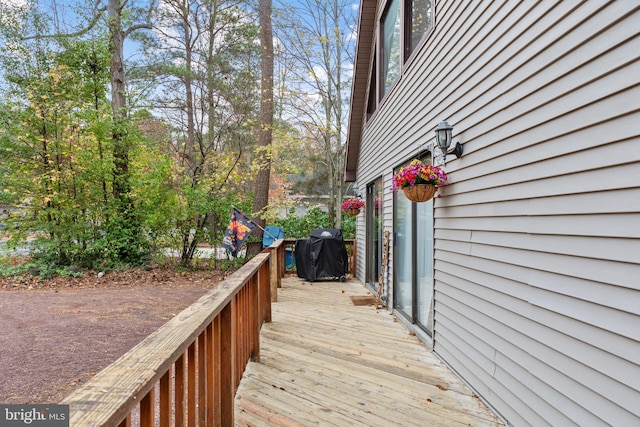 wooden terrace featuring area for grilling