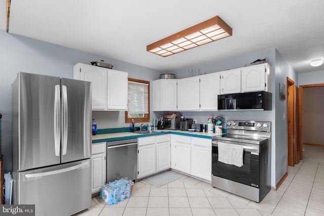 kitchen featuring white cabinets, light tile patterned floors, stainless steel appliances, and sink