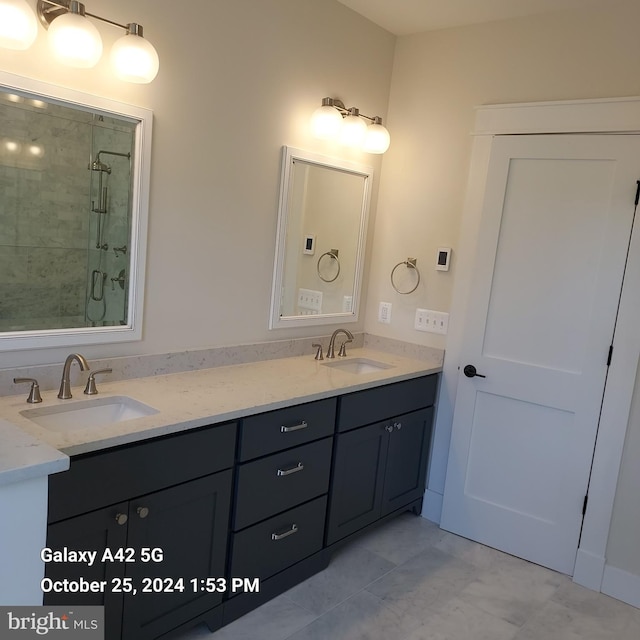 bathroom featuring vanity and a shower with shower door