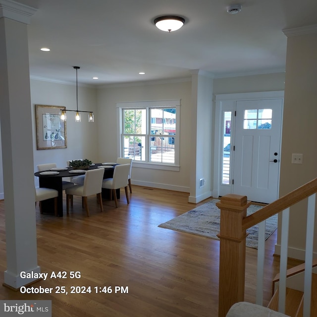 foyer with hardwood / wood-style flooring and ornamental molding