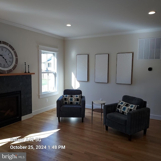 sitting room featuring ornamental molding and hardwood / wood-style floors