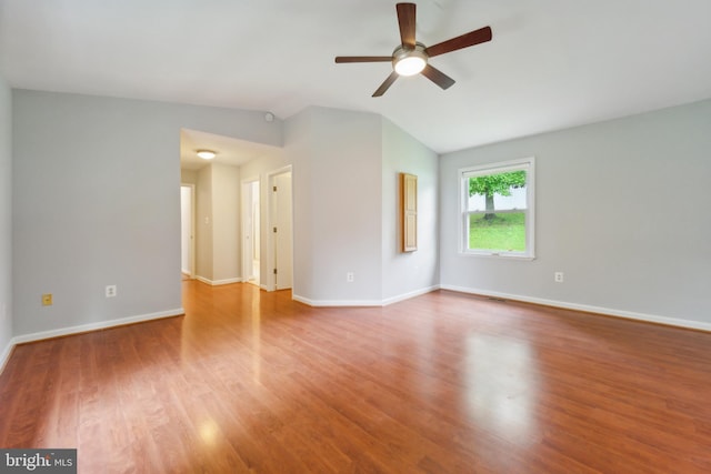 spare room featuring lofted ceiling, hardwood / wood-style flooring, and ceiling fan