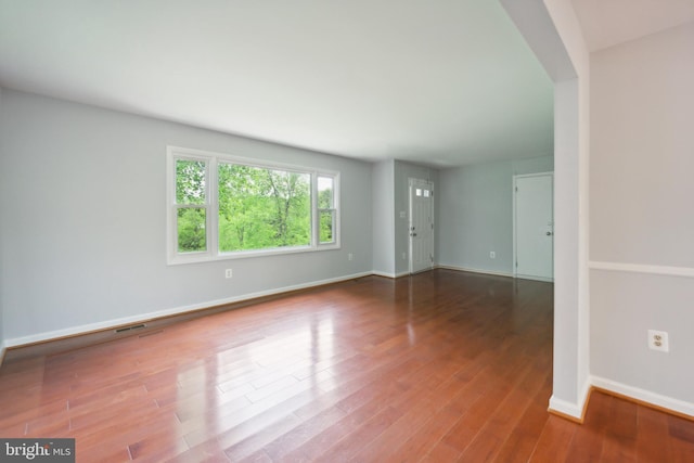 empty room with hardwood / wood-style floors