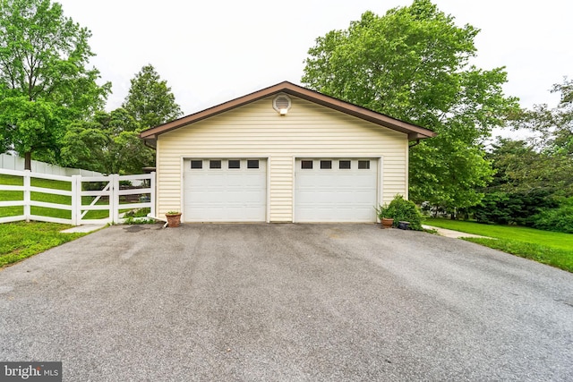 garage featuring a lawn