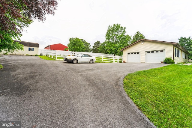 view of front of home with a front yard and a garage