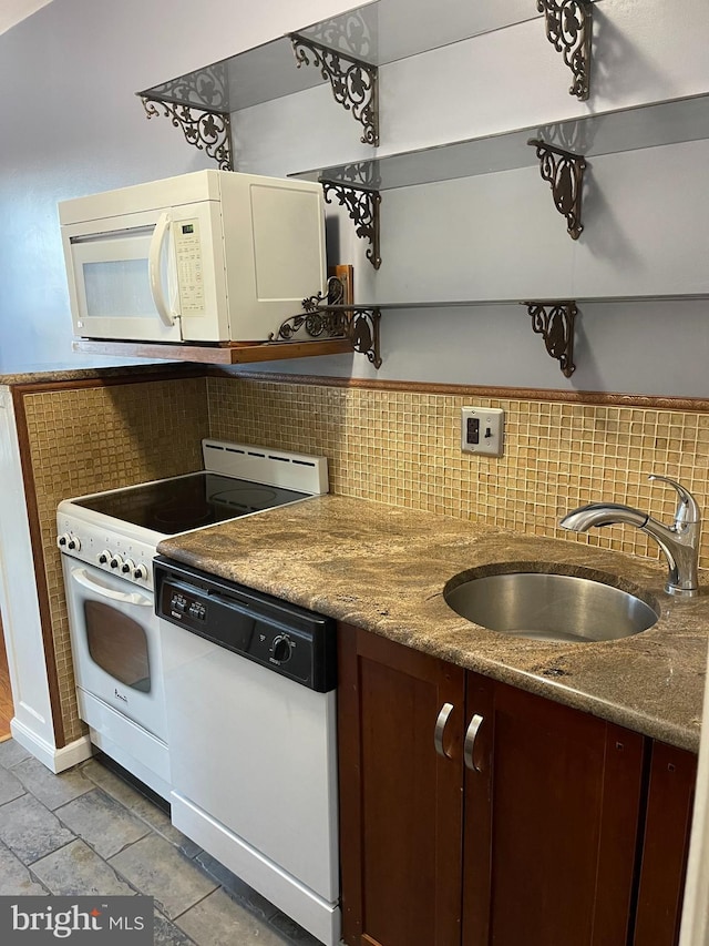 kitchen featuring white appliances, sink, and tasteful backsplash