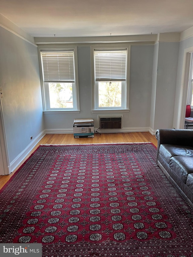 interior space with hardwood / wood-style floors and a wall mounted AC